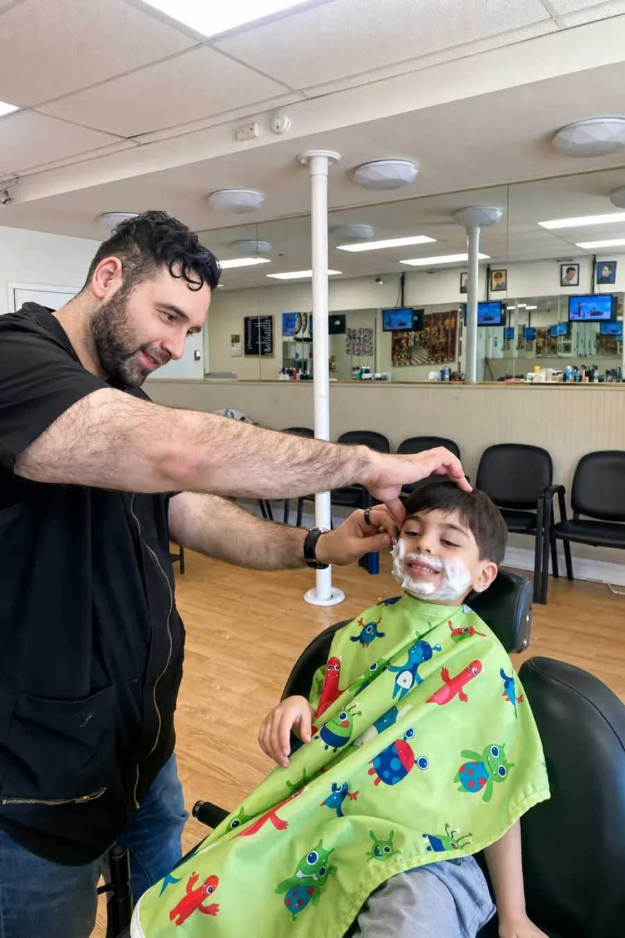 A young customer getting a kids’ haircut at Camp Ave Barbershop